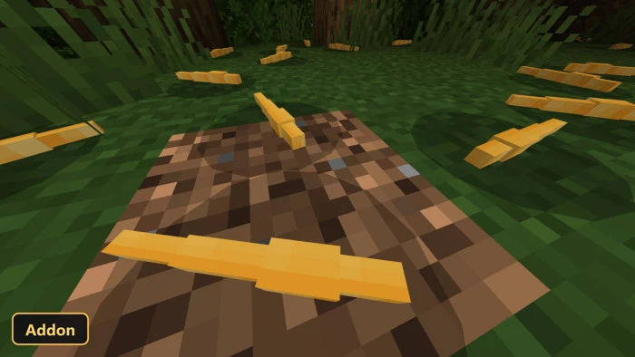 yellow worm-like creatures on a dirt patch in a forest