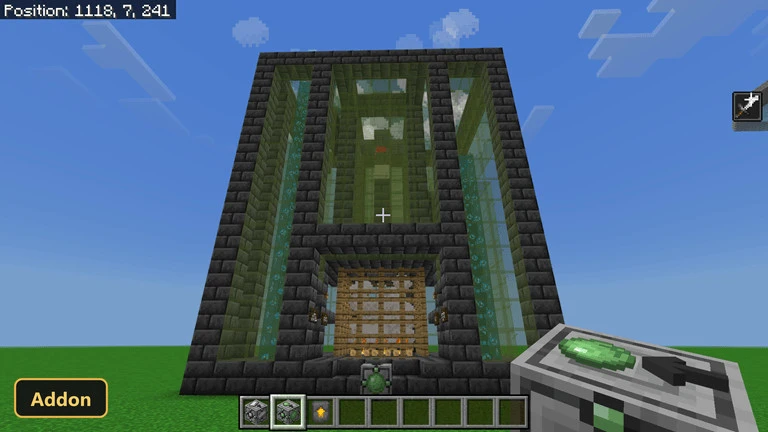 large dark stone and glass structure on a grassy plain