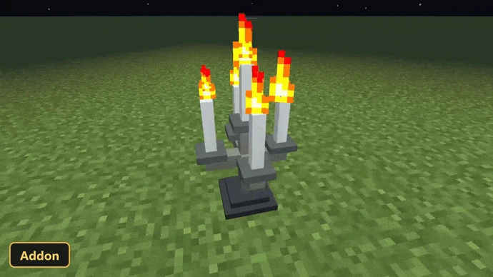 candelabra with five lit candles on a grassy plain at night
