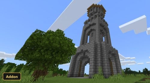 a tall stone tower next to a large tree in a grassy field
