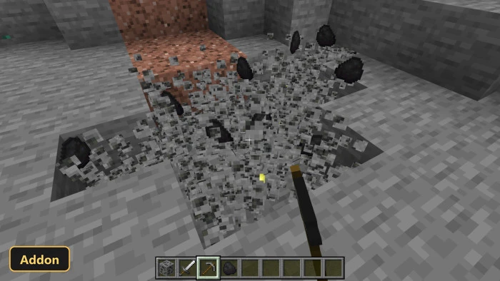 player mining coal in a cave, stone and coal particles flying
