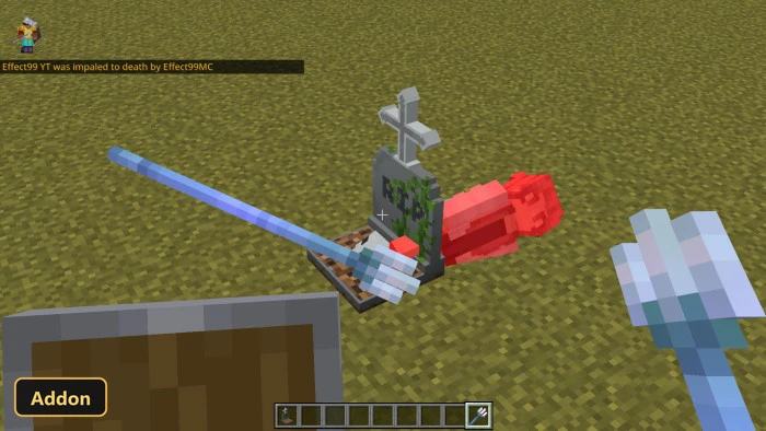 trident and other items next to a gravestone on grass