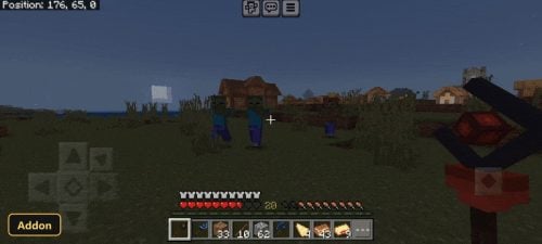 Player facing zombies in a village at night, holding a red scepter