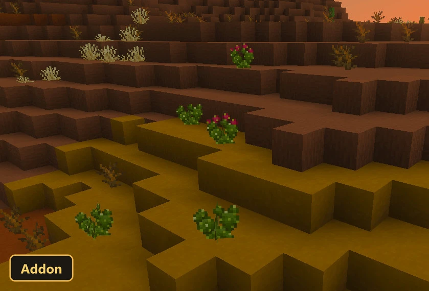 desert landscape with yellow and brown blocks, small green and pink plants