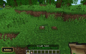player holding a bag of mulch, placing it on dirt