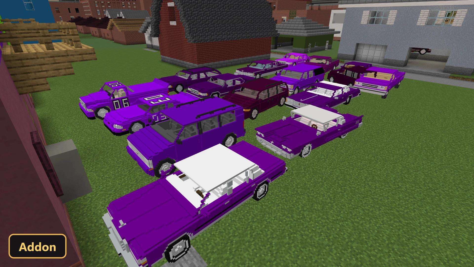 a collection of purple cars parked on grass in a town